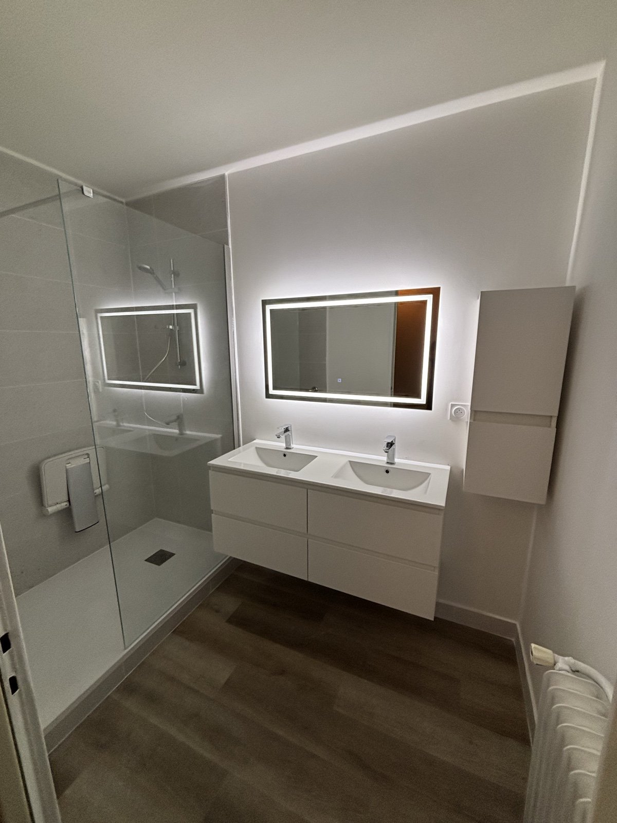 Salle de bain sur mesure réalisée par GALAND — douche italienne plain-pied, double vasque suspendue et miroir LED rétroéclairé